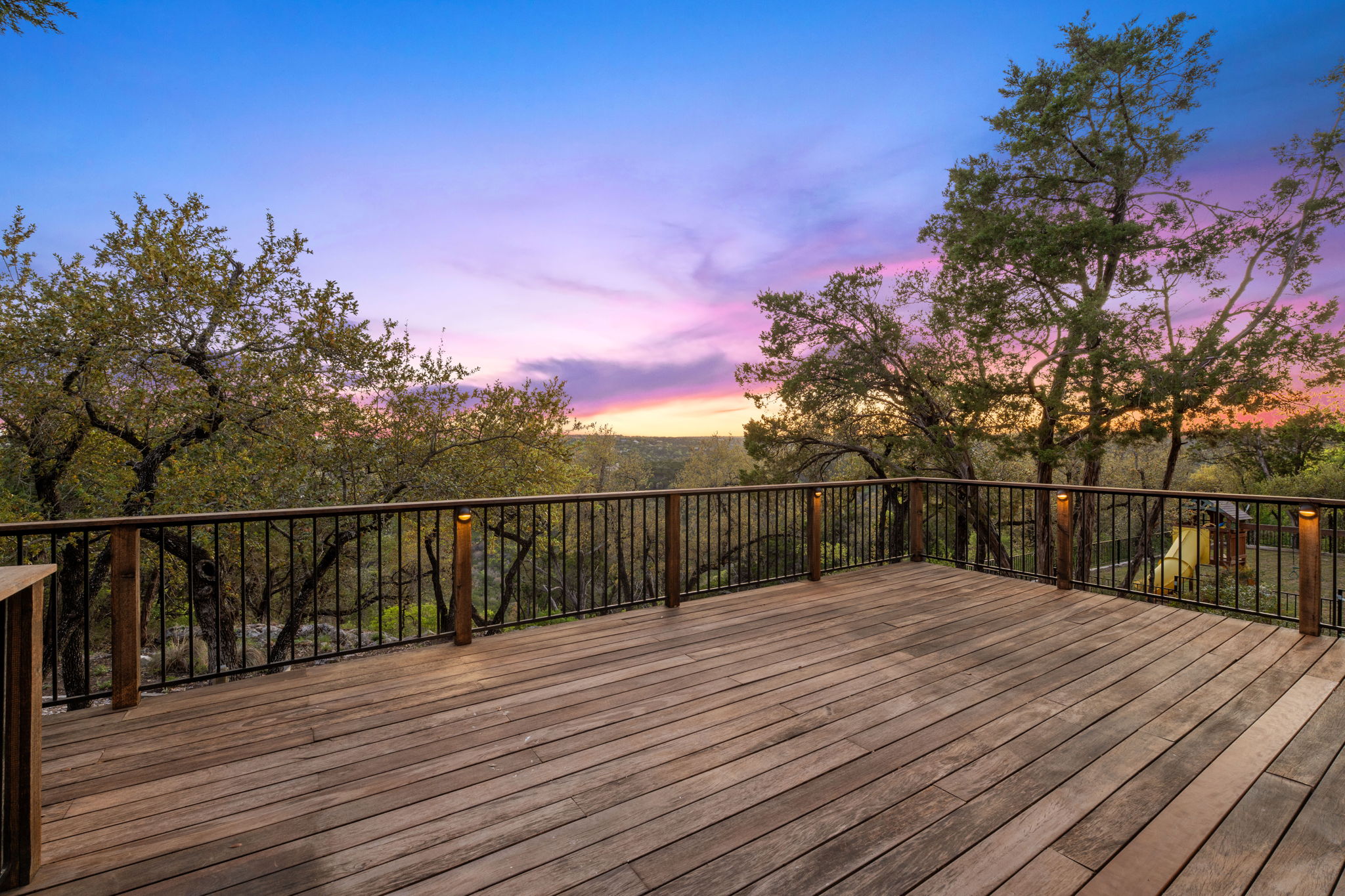 7801 Image Cove Austin, TX 78730 - Photo 2 of 26 a balcony with wooden floor and city view