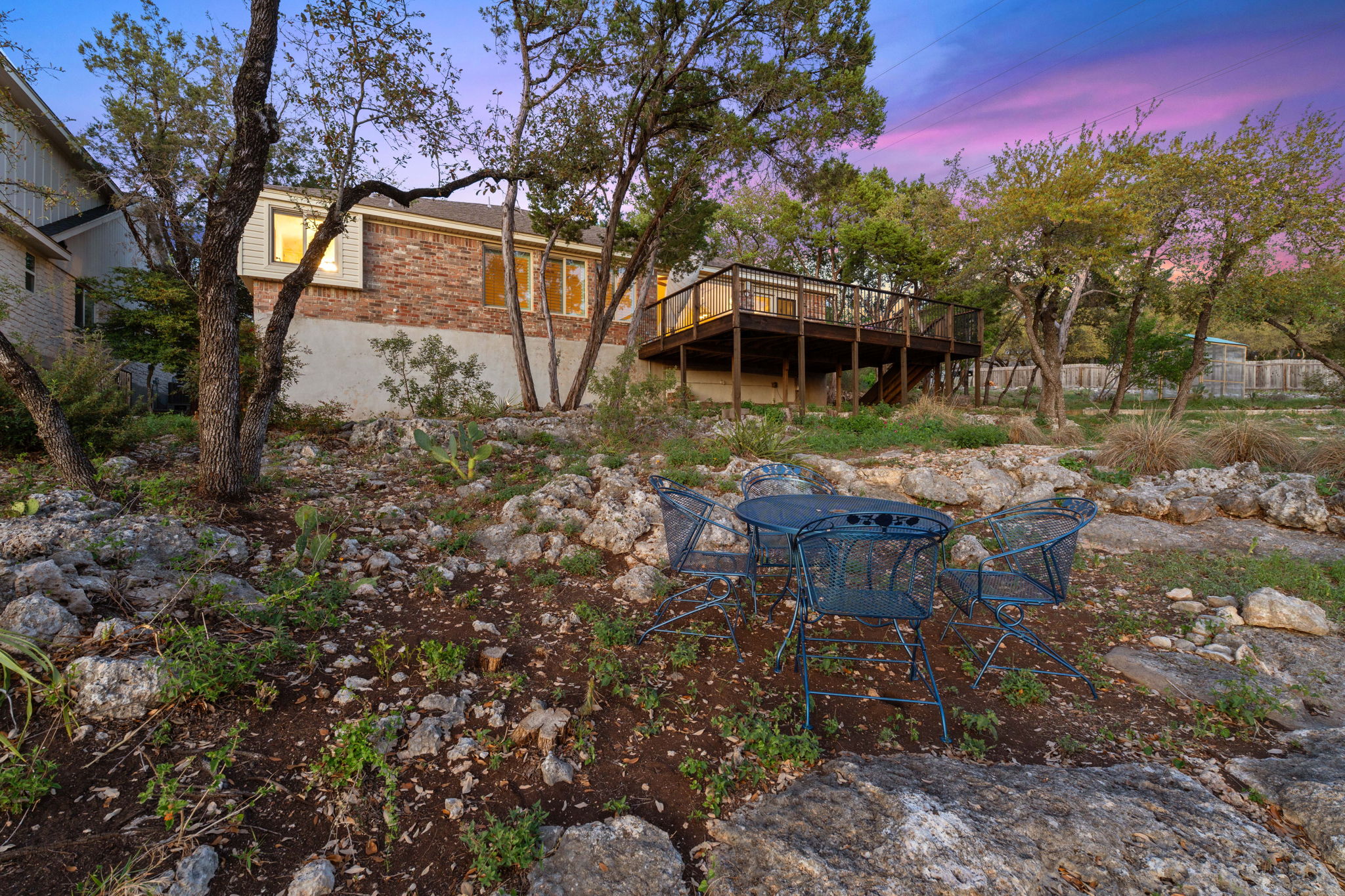 7801 Image Cove Austin, TX 78730 - Photo 24 of 26 a backyard of a house with table and chairs