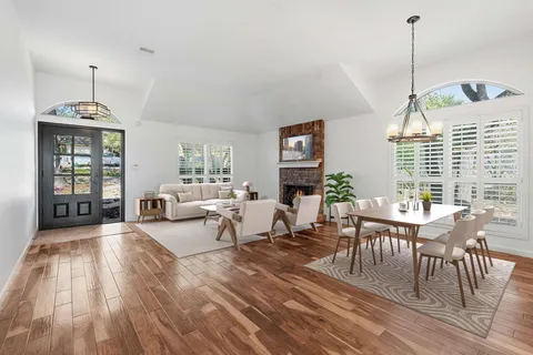 a living room with furniture and wooden floor