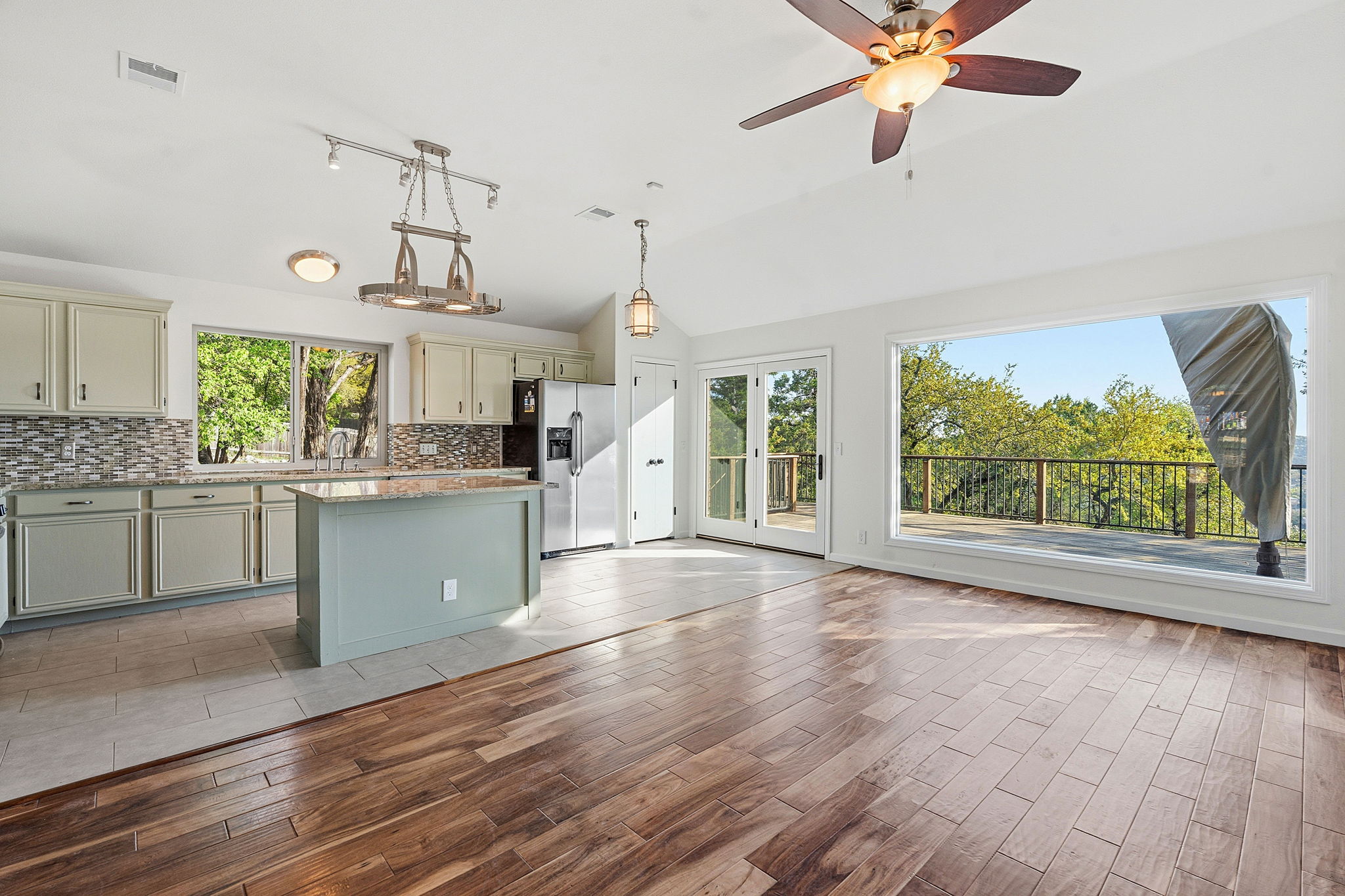 7801 Image Cove Austin, TX 78730 - Photo 7 of 26 a kitchen with kitchen island a large counter top space a sink stainless steel appliances and cabinets