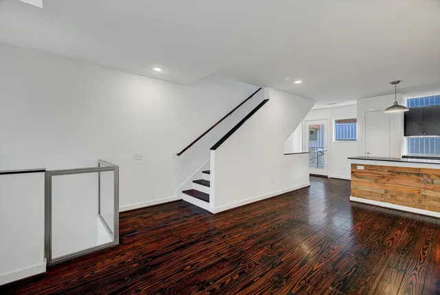 a view of entryway and hall with wooden floor