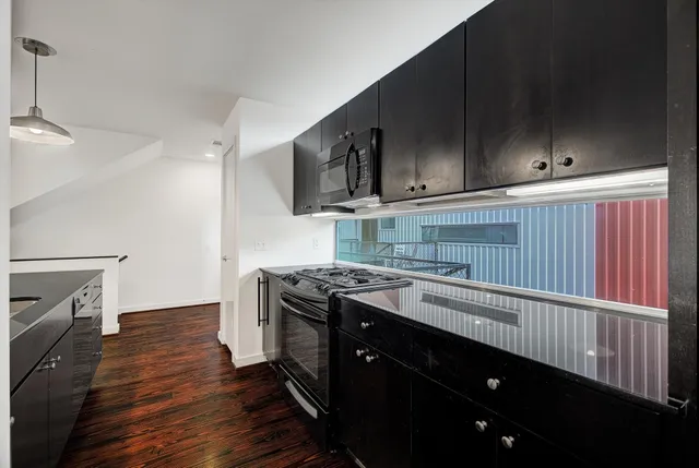 a kitchen with a sink stove and cabinets