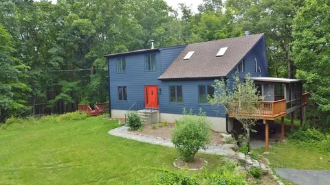 a aerial view of a house with table and chairs in patio