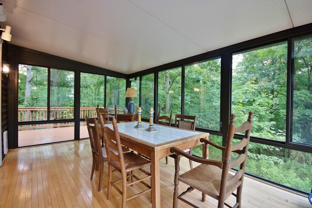 107 Lane Gate Road Cold Spring, NY 10516 - Photo 13 of 45 a view of a dining room with furniture large windows and wooden floor