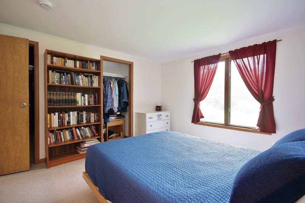 107 Lane Gate Road Cold Spring, NY 10516 - Photo 14 of 45 a bedroom with a large bed and a window