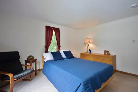 a bedroom with a bed and window