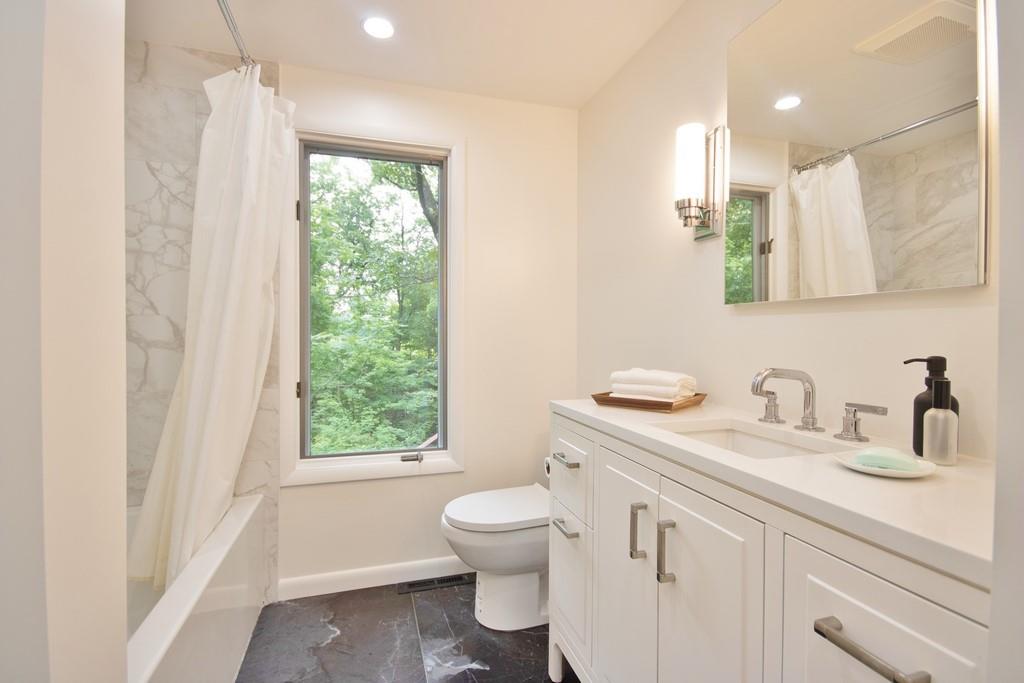 107 Lane Gate Road Cold Spring, NY 10516 - Photo 16 of 45 a bathroom with a toilet a sink a mirror a window and vanity