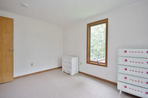a view of room with window and cabinet