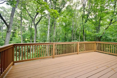 a view of balcony with wooden floor and fence