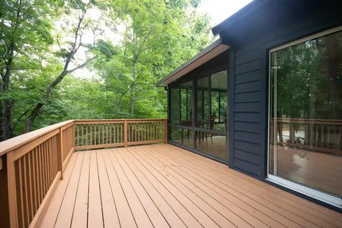 a view of balcony with wooden floor and fence