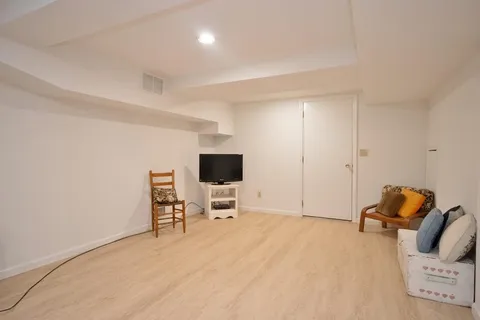 a bedroom with a bed and a chair in it