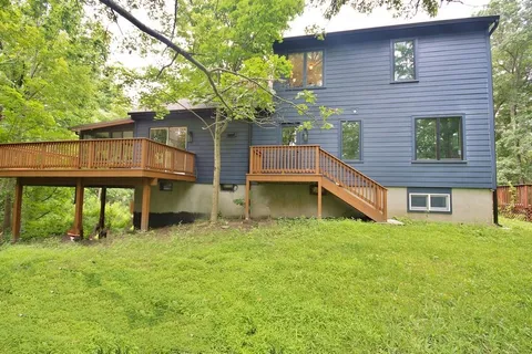 a backyard of a house with table and chairs