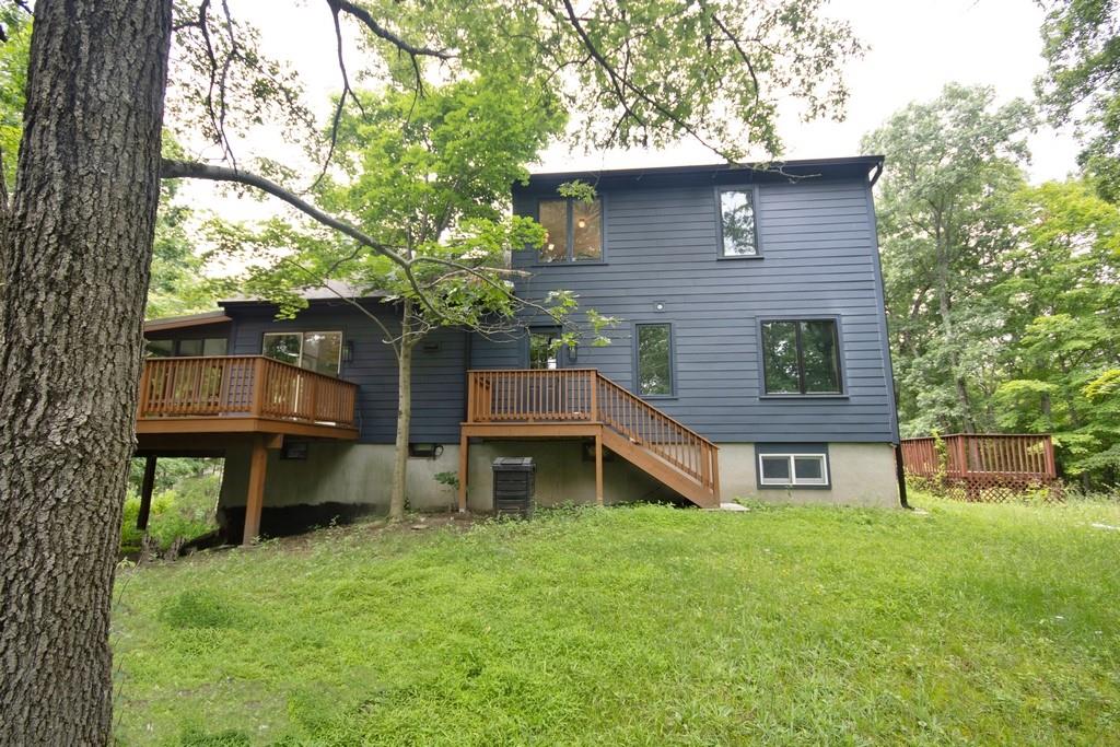 107 Lane Gate Road Cold Spring, NY 10516 - Photo 36 of 45 a front view of a house with a garden and plants