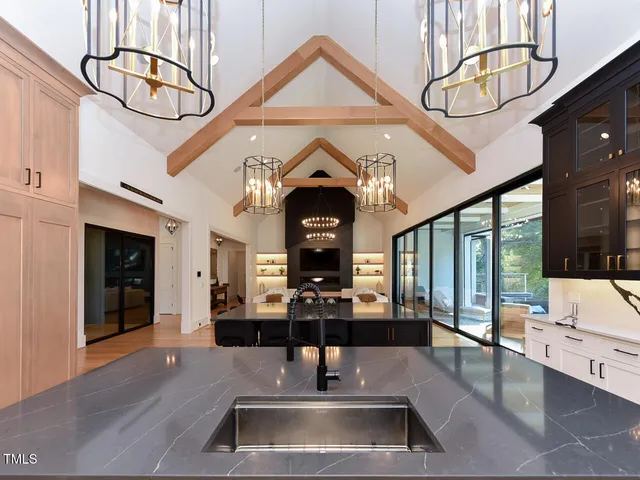 a kitchen with stainless steel appliances granite countertop a sink and wooden cabinets