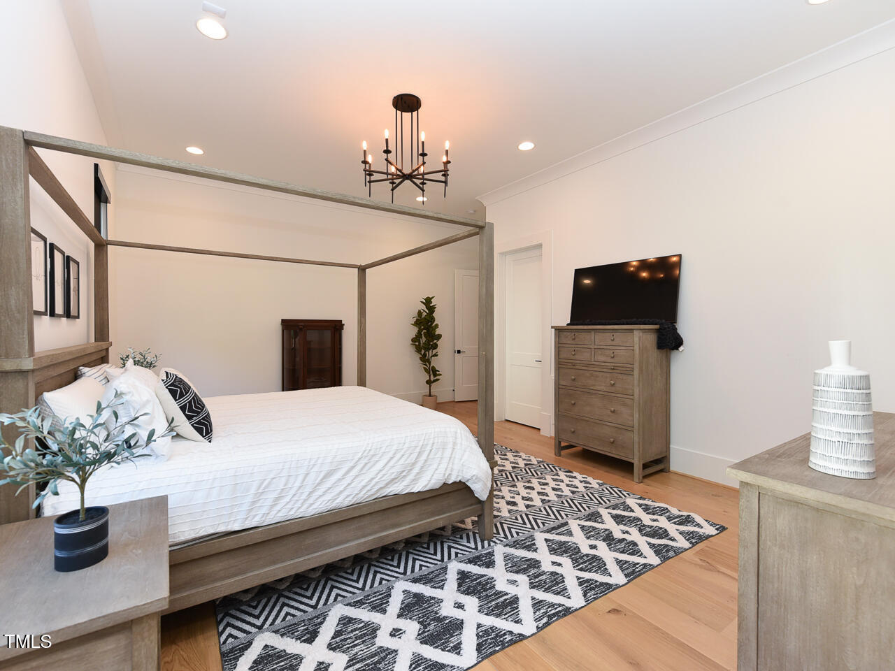 1425 Sky Vista Way Raleigh, NC 27613 - Photo 38 of 67 a bedroom with bed and wooden floor