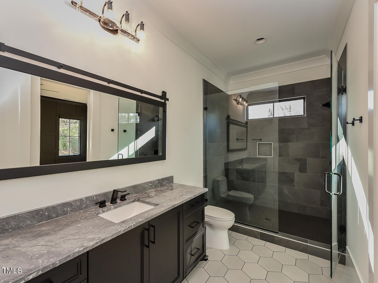 1425 Sky Vista Way Raleigh, NC 27613 - Photo 56 of 67 a bathroom with a sink a toilet and shower