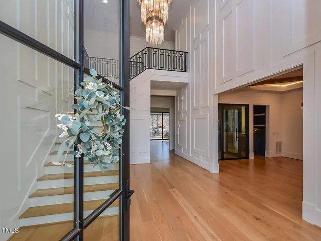 a living room with furniture a flat screen tv and a floor to ceiling window