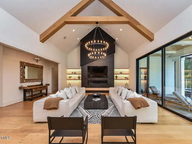 a living room with furniture ceiling fan and a large window
