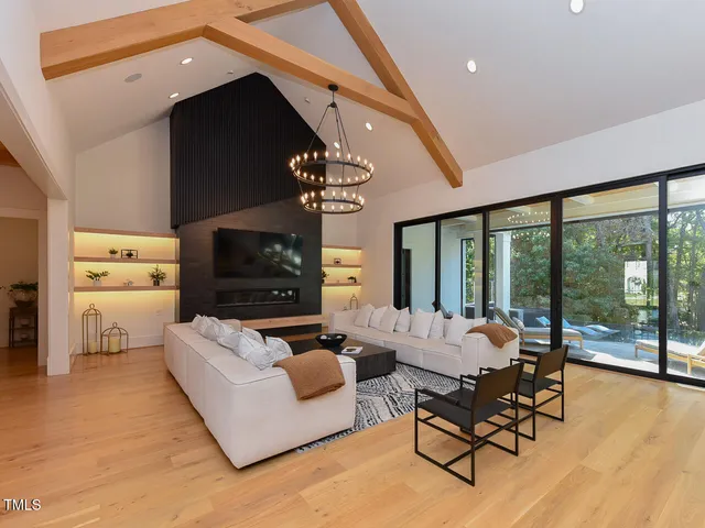 a living room with furniture a fireplace and white walls