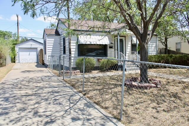 4623 Crockett Street Amarillo, TX 79110 - Photo 3 of 9 a front view of a house with garden