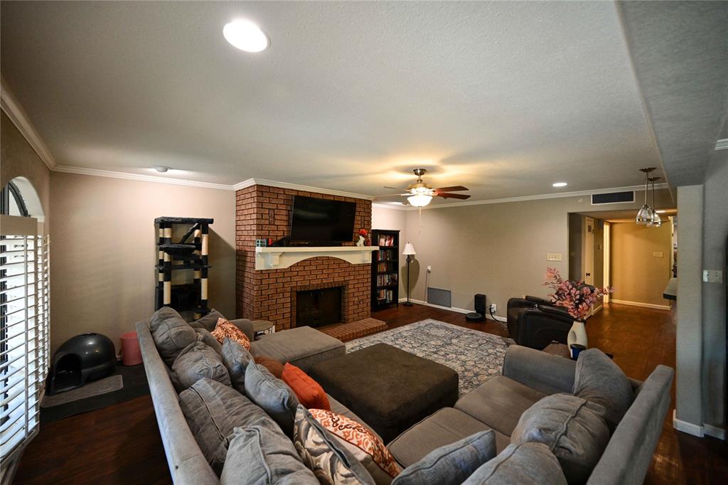 32 Rue Maison Abilene, TX 79605 - Photo 3 of 40 a living room with furniture a fireplace and a flat screen tv