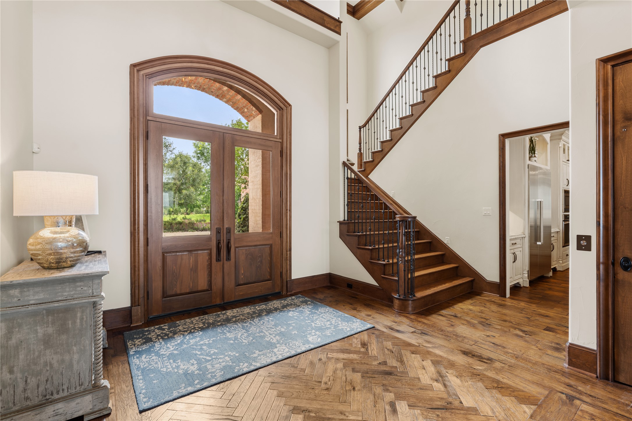 12349 Longmire Trace Conroe, TX 77304 - Photo 5 of 48 Grand foyer with arched double doors, sweeping staircase, and rich hardwood floors welcomes you home.