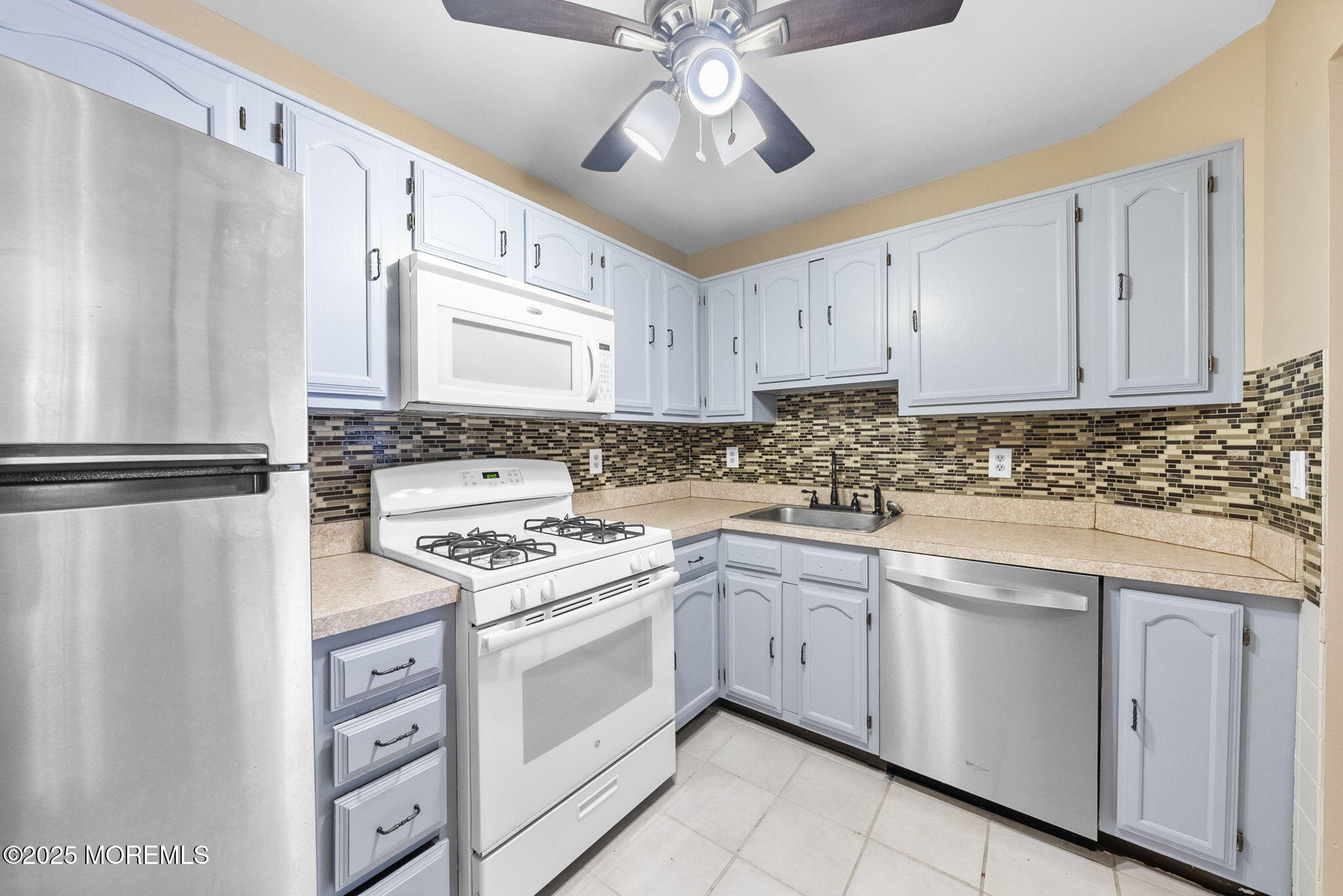 353 Sequoia Court Howell, NJ 07731 - Photo 12 of 27 a kitchen with cabinets appliances a sink and a window