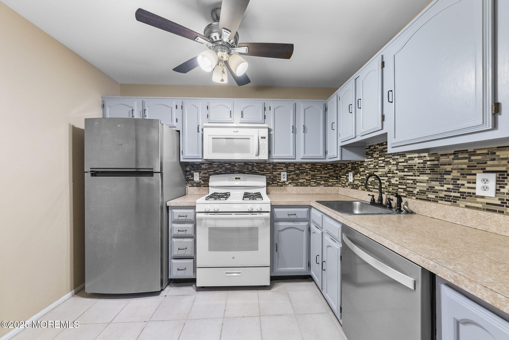 353 Sequoia Court Howell, NJ 07731 - Photo 13 of 27 a kitchen with stainless steel appliances granite countertop a refrigerator sink and white cabinets