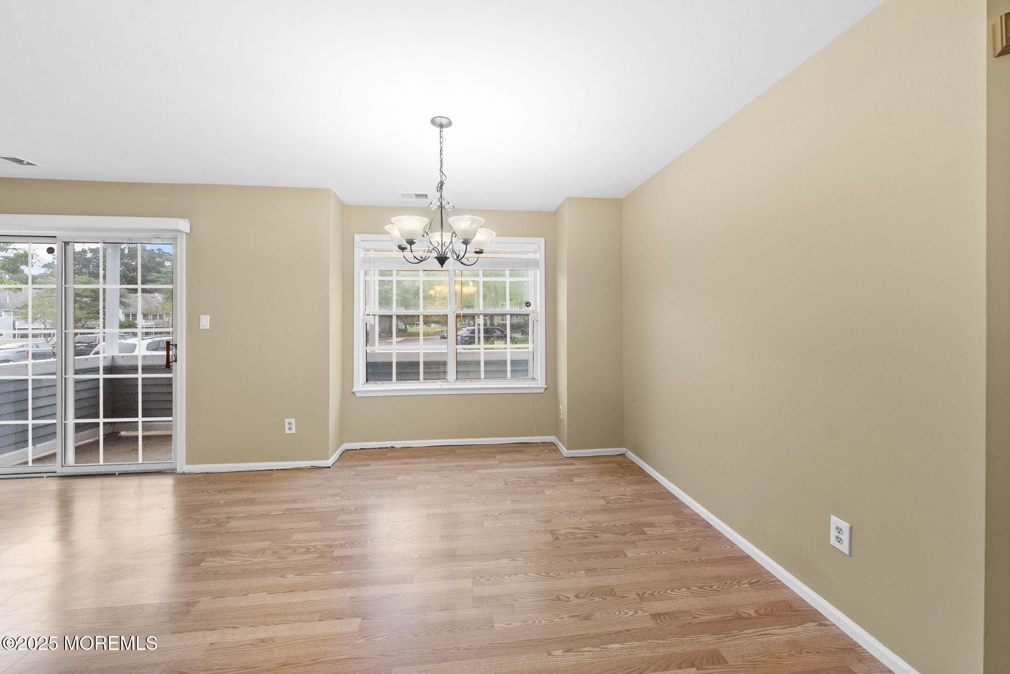 353 Sequoia Court Howell, NJ 07731 - Photo 6 of 27 a view of an empty room with wooden floor and a window