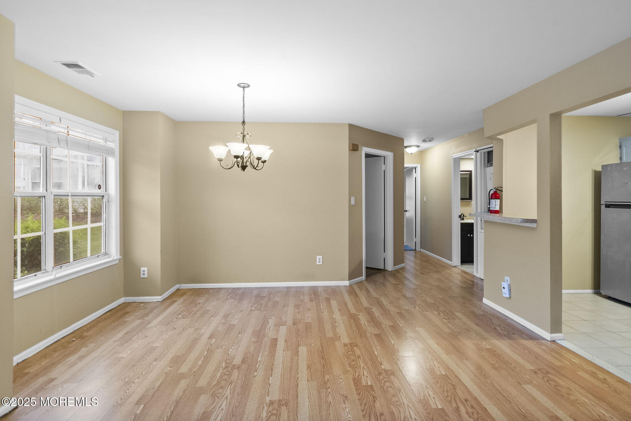 353 Sequoia Court Howell, NJ 07731 - Photo 9 of 27 wooden floor in an empty room with a window