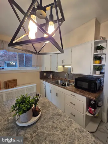 a kitchen with a sink and cabinets