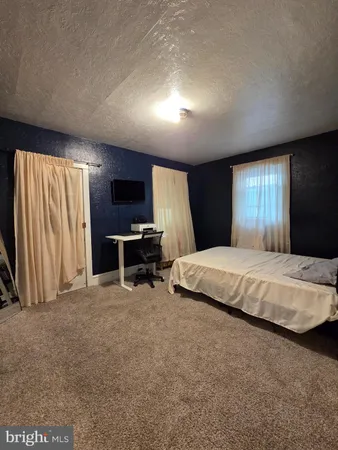 a bed room with a bed and a television