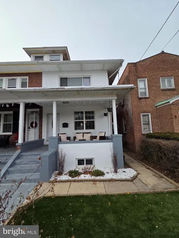 a view of a house with backyard porch and furniture