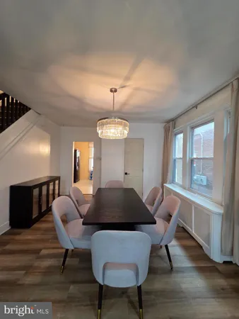 a living room with furniture a window and a chandelier
