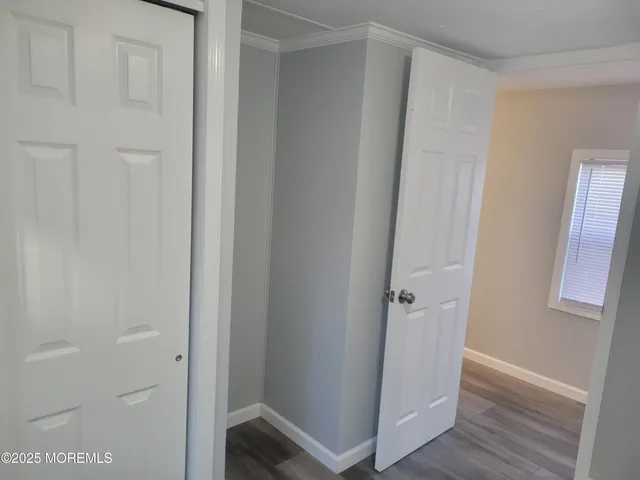 an empty room with wooden floor and closet