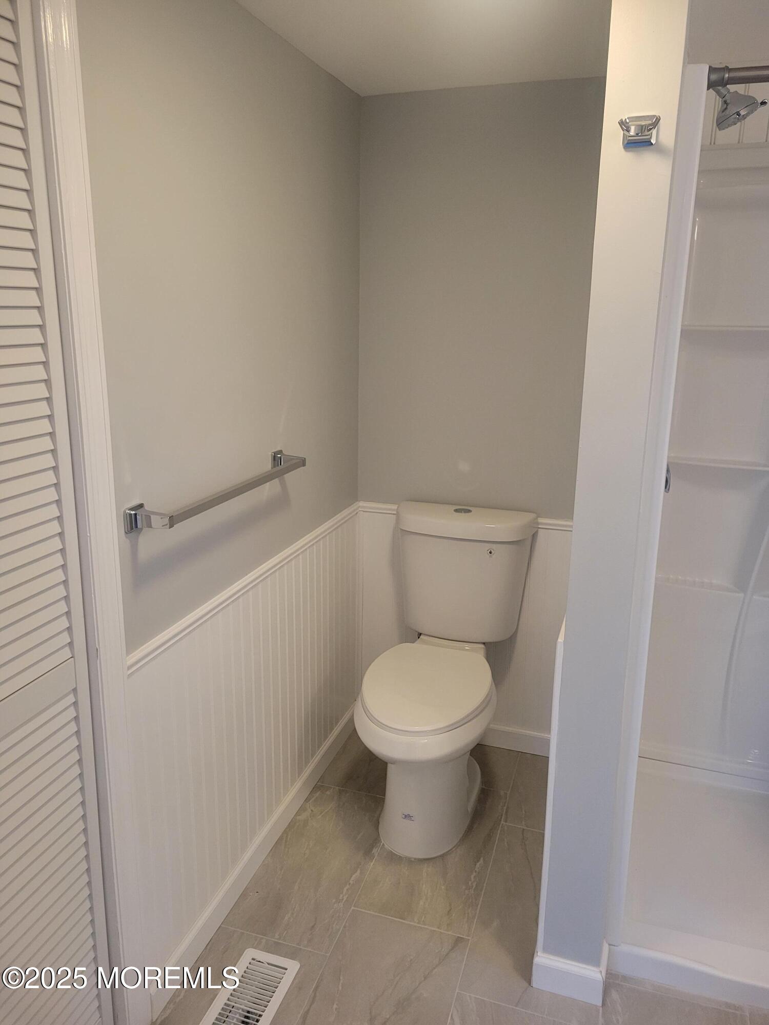 20 Judith Way Jackson, NJ 08527 - Photo 15 of 22 a white toilet sitting next to a shower