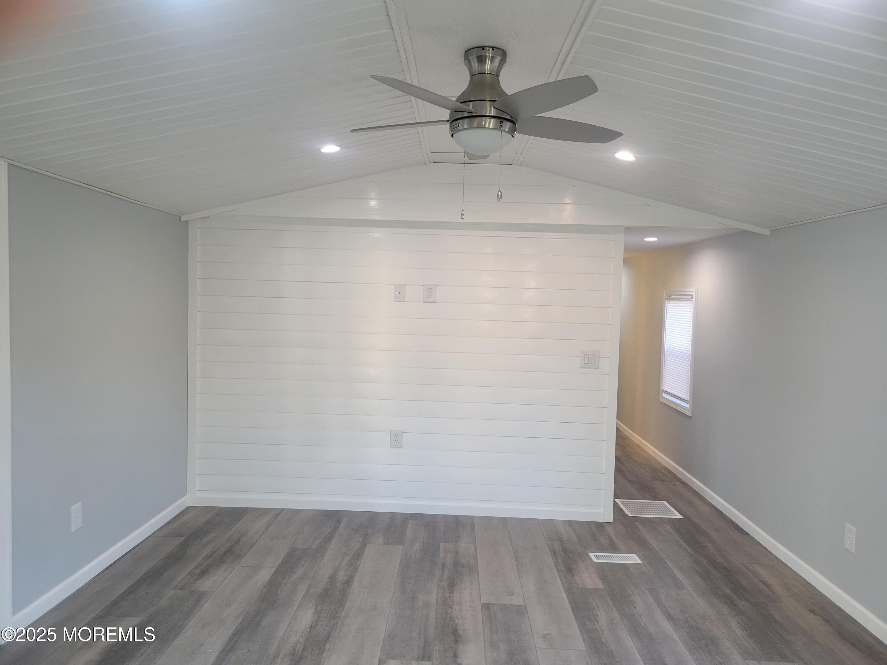 20 Judith Way Jackson, NJ 08527 - Photo 4 of 22 an empty room with wooden floor fan and windows