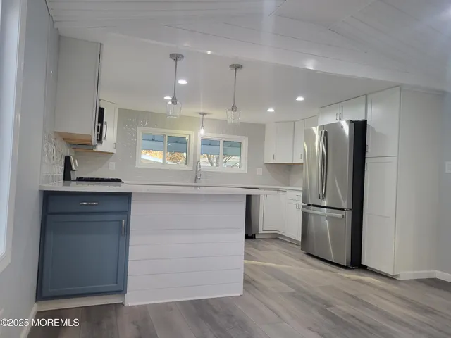 a kitchen with a refrigerator and a stove top oven