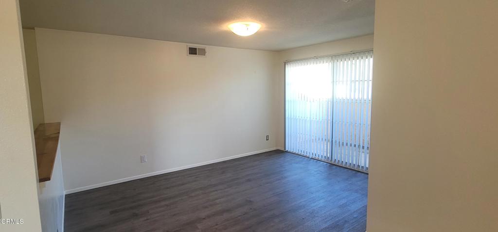 2077 Blackberry Circle Oxnard, CA 93036 - Photo 11 of 20 a view of an empty room with wooden floor and a window