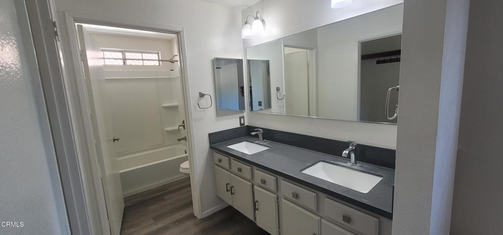 2077 Blackberry Circle Oxnard, CA 93036 - Photo 17 of 20 a bathroom with a double vanity sink and mirror