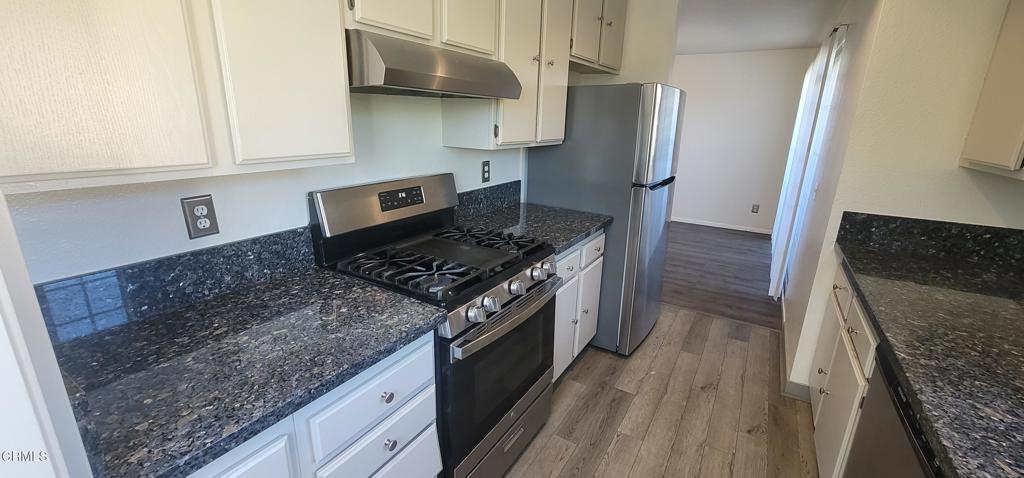 2077 Blackberry Circle Oxnard, CA 93036 - Photo 5 of 20 a kitchen with stainless steel appliances granite countertop a refrigerator and a stove