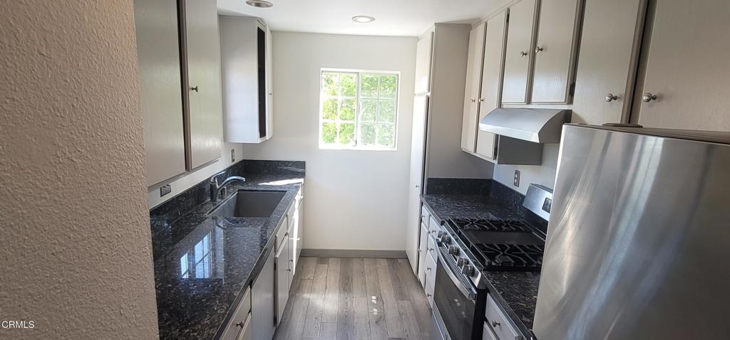 2077 Blackberry Circle Oxnard, CA 93036 - Photo 8 of 20 a kitchen with a refrigerator a stove and a window