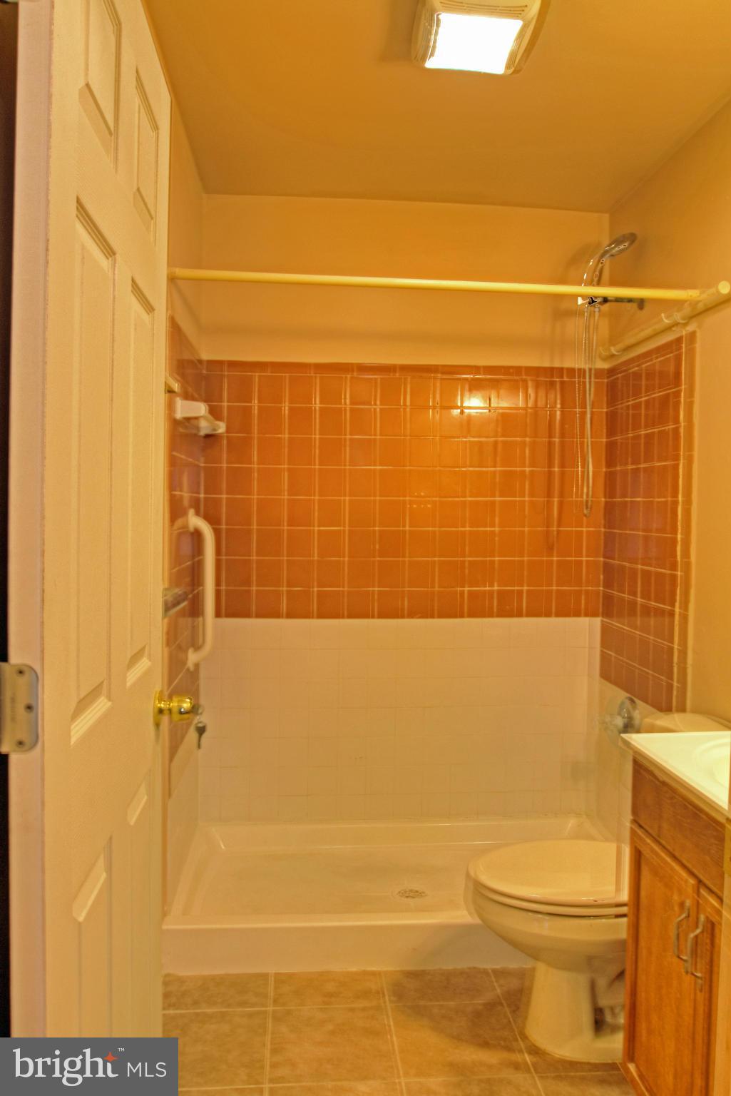 3705 Collier Road Randallstown, MD 21133 - Photo 19 of 30 a bathroom with a toilet and shower