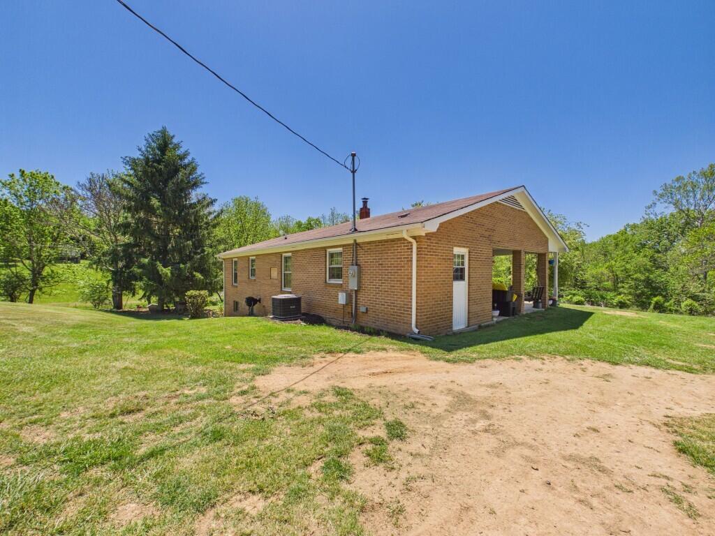 404 Baker Island Road Max Meadows, VA 24360 - Photo 11 of 66 a front view of a house with a yard and garage
