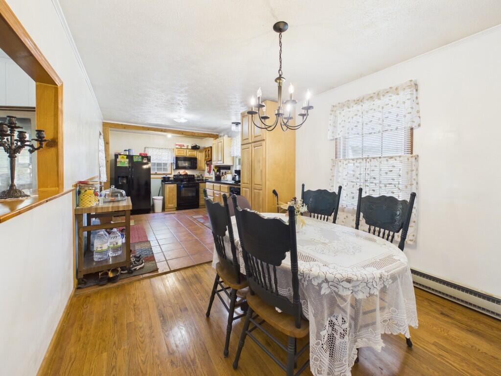 404 Baker Island Road Max Meadows, VA 24360 - Photo 25 of 66 a view of a dining room with furniture a chandelier and wooden floor