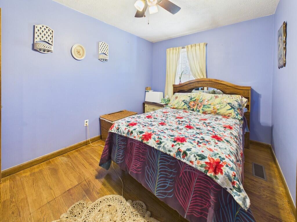 404 Baker Island Road Max Meadows, VA 24360 - Photo 36 of 66 a bedroom with a bed and a chandelier