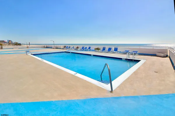 a view of a swimming pool and an outdoor space