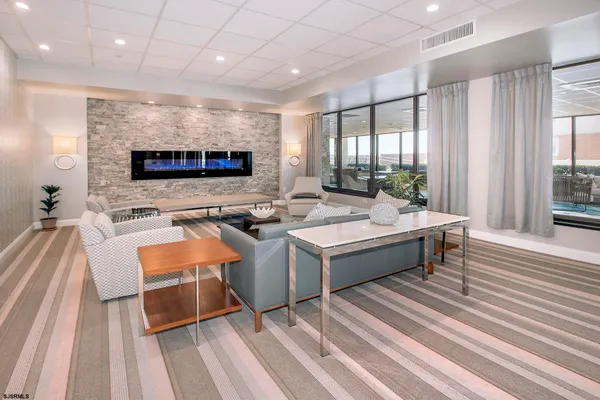 a living room with patio furniture and a flat screen tv