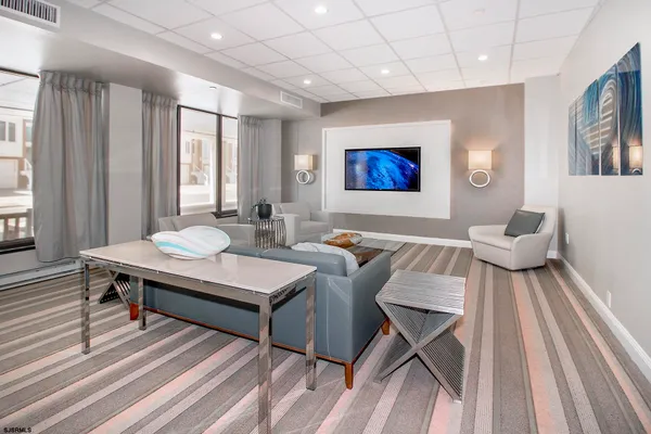 a living room with furniture a rug and a large window