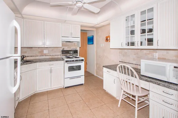 a kitchen with a stove a sink and a refrigerator